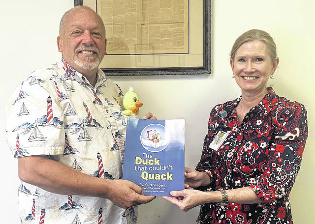 
			
				                                Katelin Gandee | The Laurinburg Exchange
                                W. Curt Vincent, editor of The Laurinburg Exchange, presented Sharon Castelli, literacy program director with Scotland County Schools, with 20 copies of his new children’s book, ‘The Duck That Couldn’t Quack.’ The books, all signed by Vincent, will be placed in the school district’s Free Little Library sites around the county.
 
			
		