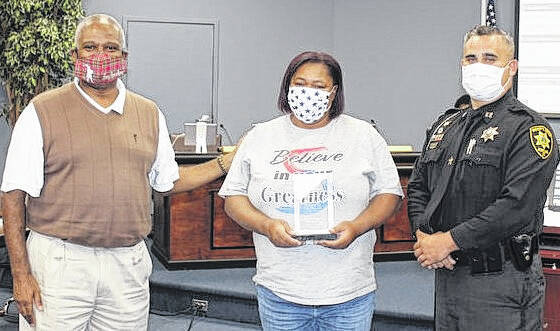  Courtesy photo Scotland County Schools bus driver Felisa McKeithan was honored Monday night during the Scotland County Board. McKeithan received recognition by Scotland County Sheriff’s Office Capt. John Hunt for her quick thinking during a bus accident on Aug. 26, 2021. McKeithan was driving Bus 38 was driving south on Hwy. 401 when a vehicle entered their lane of traffic and struck the bus. Hunt gave McKeithan an award from the Scotland County Sheriff’s Office honoring her for her passion and commitment to the children in the county. Board member Tony Spaulding also presented the award. 